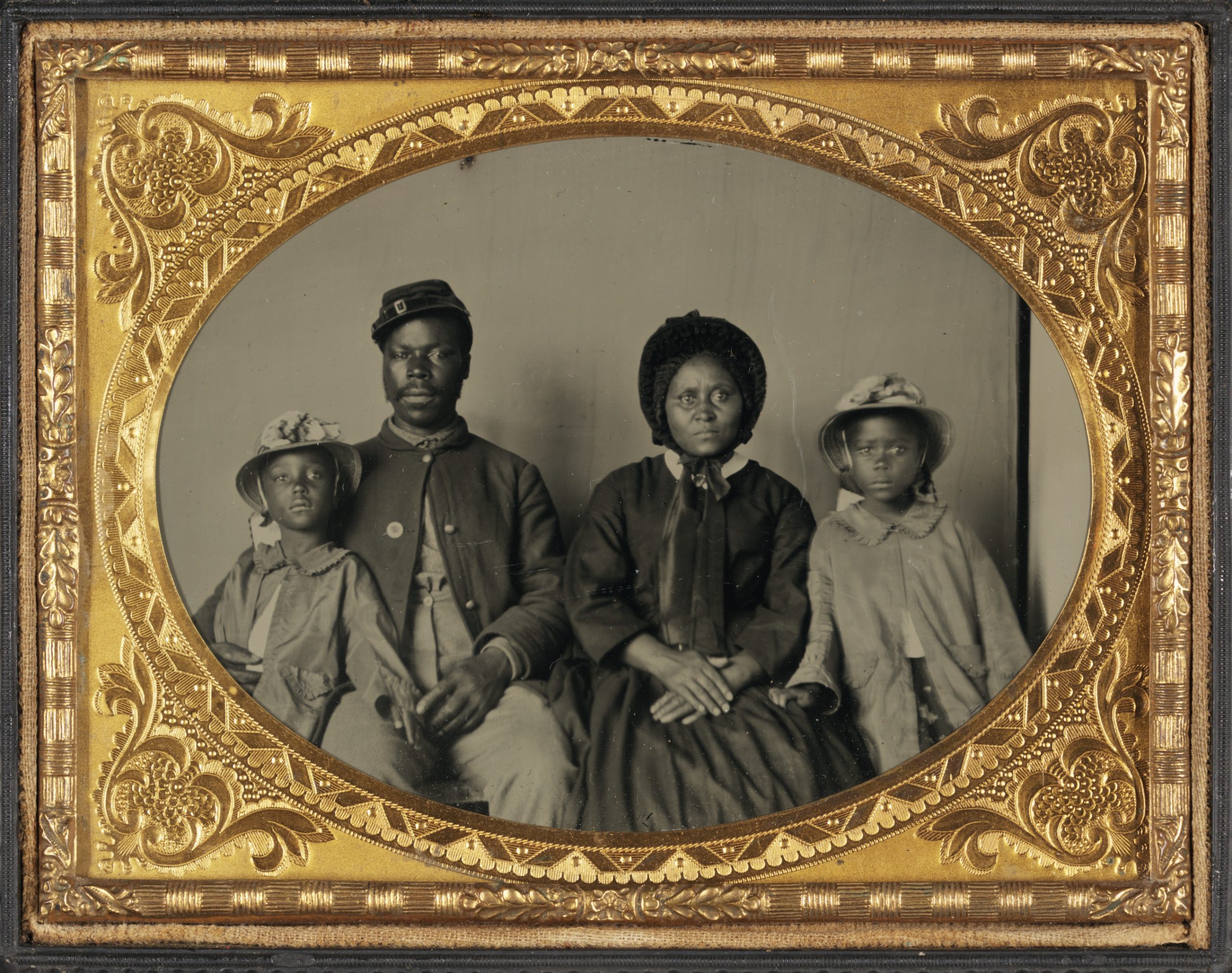 This is a rare photograph of a black Union soldier in uniform with his wife and two daughters. Abolitionists advocated the recruitment of black soldiers during the Civil War.