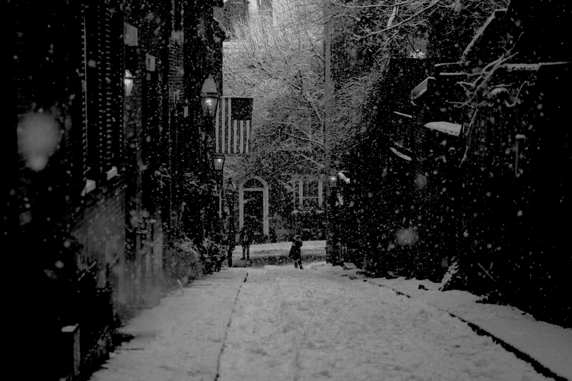 Snowy street in an old city This is a modern photograph of a colonial city in the snow at night.